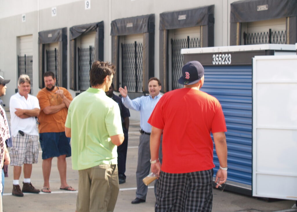 Auctioneer calling bids at a live sale, representing BoldBids Houston estate auctions, estate sales, and probate‑related liquidation services