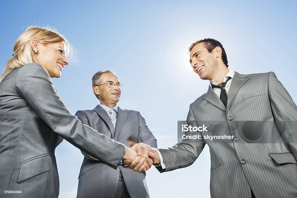 Professional handshake representing executors, attorneys, and property managers served by BoldBids