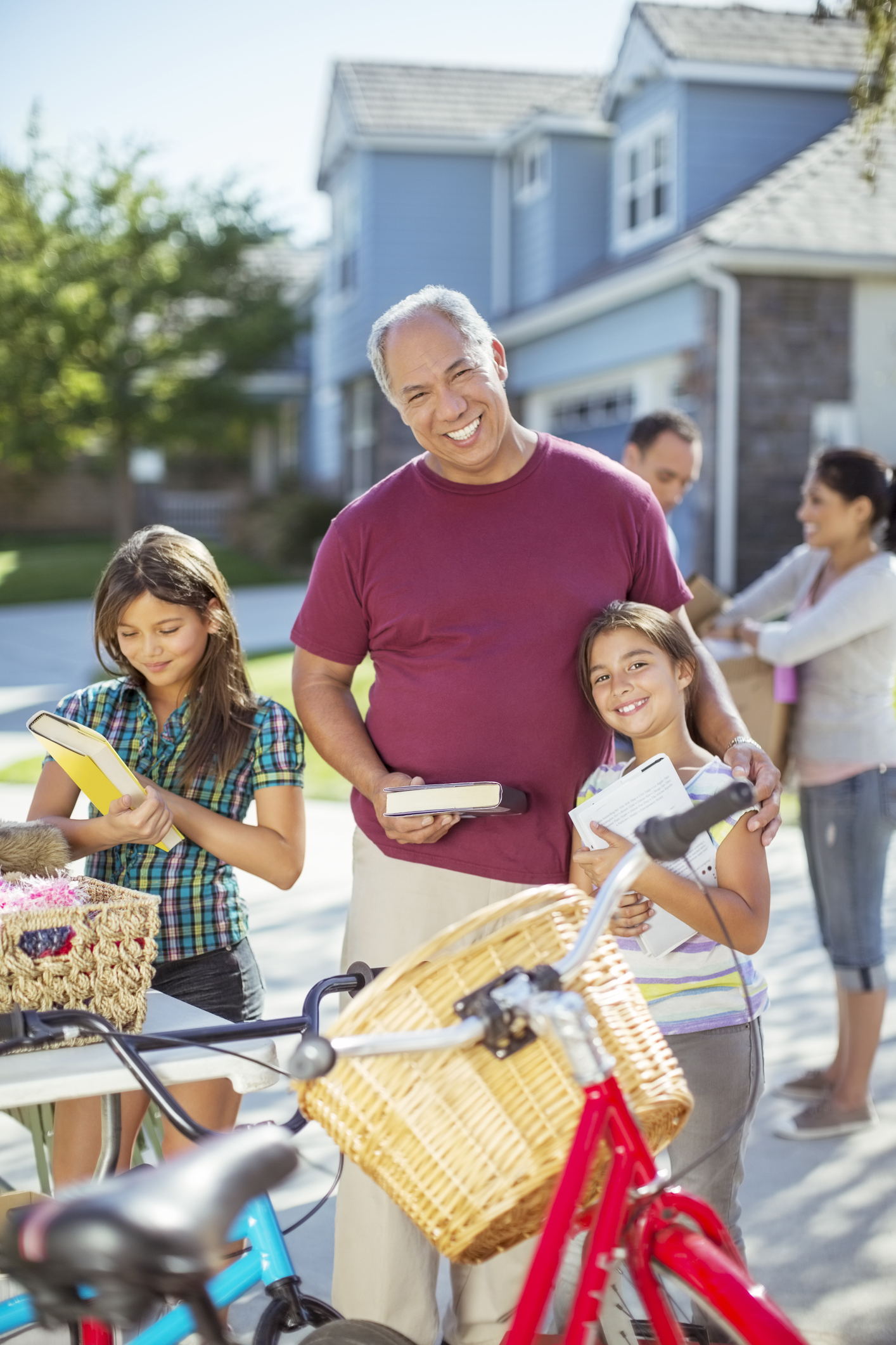 Grandfather and granddaughter preparing items for a yard sale, representing BoldBids Houston estate sale and probate‑related selling services